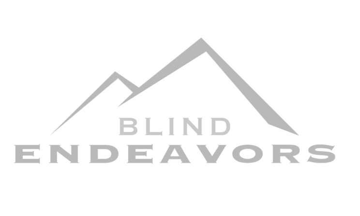 Blind Endeavors Logo with two mountain peaks and a sun in the background.